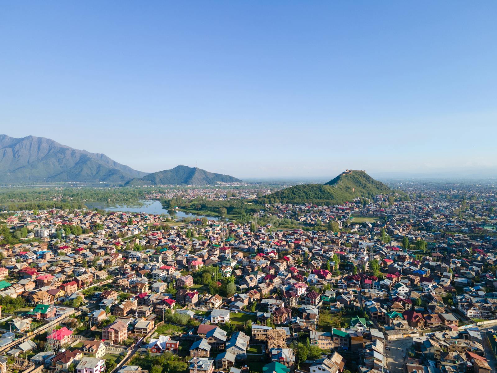 A stunning aerial shot of Srinagar showcasing the city's lush landscape and surrounding mountains.