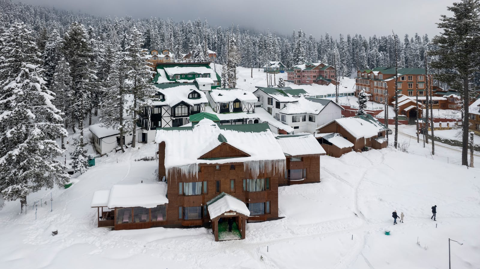 Aerial view of snow-covered chalets in Gulmarg during winter.