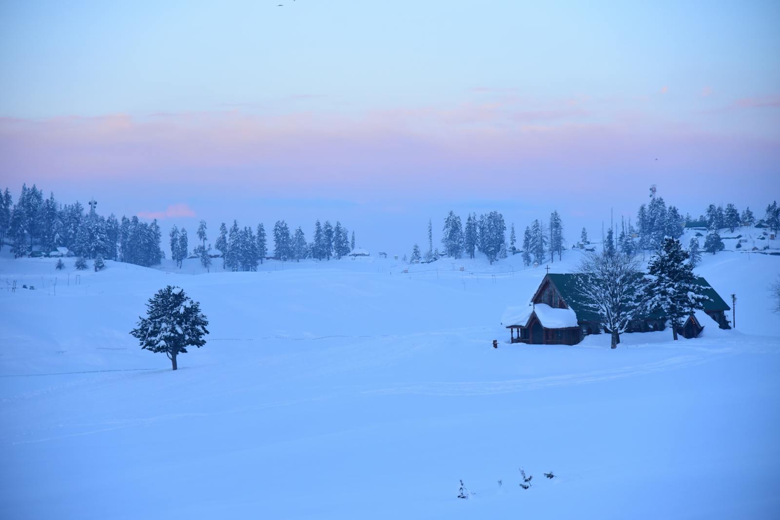 A House on a Snowy Field at Sunset